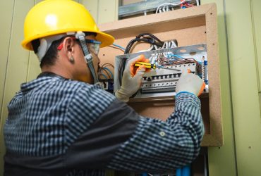 Electrician Installing Socket In New House,Electrician working safely on switches and sockets of a residential electrical system.