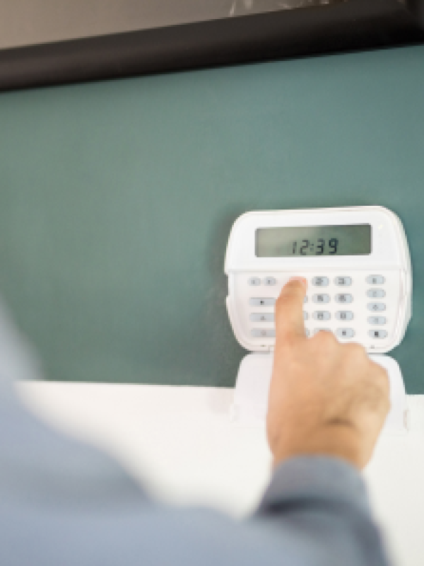 closeup-hand-man-using-keypad-arm-his-home-alarm-system